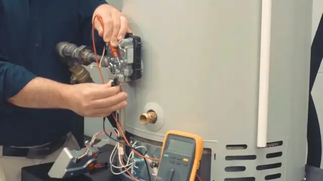 Hands testing the wiring of a residential water heater with a multimeter